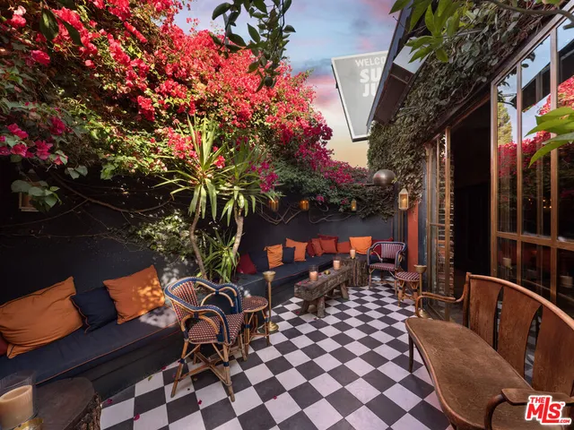 a backyard of a house with table and chairs