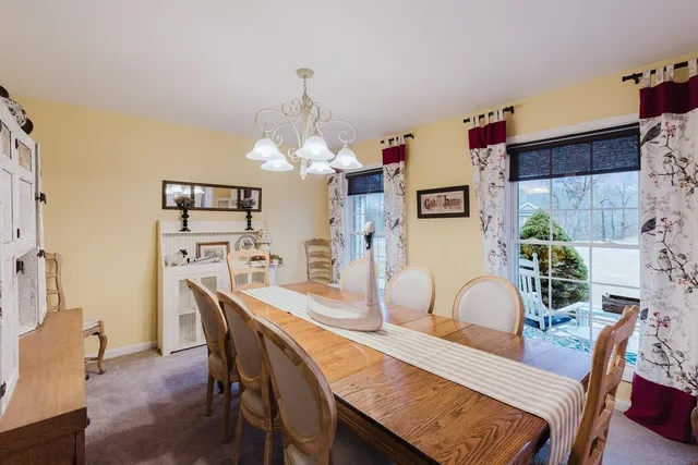 a dining room with furniture window and wooden floor