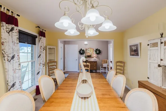 a dining room with furniture window and wooden floor