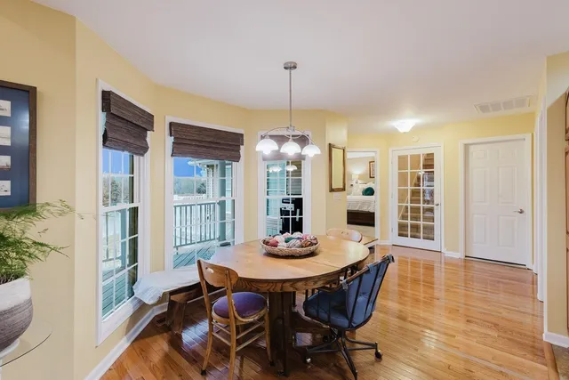 a room with pool table and windows
