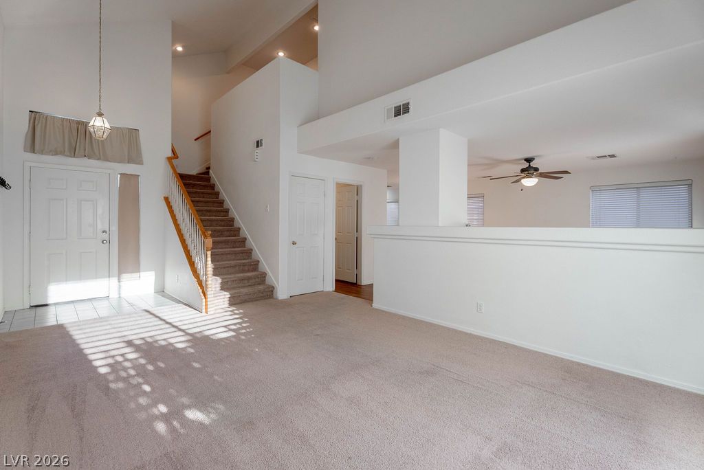 8379 Rockefeller Street Las Vegas, NV 89123 - Photo 3 of 36 Vaulted ceilings and an open staircase create an airy, welcoming entryway.