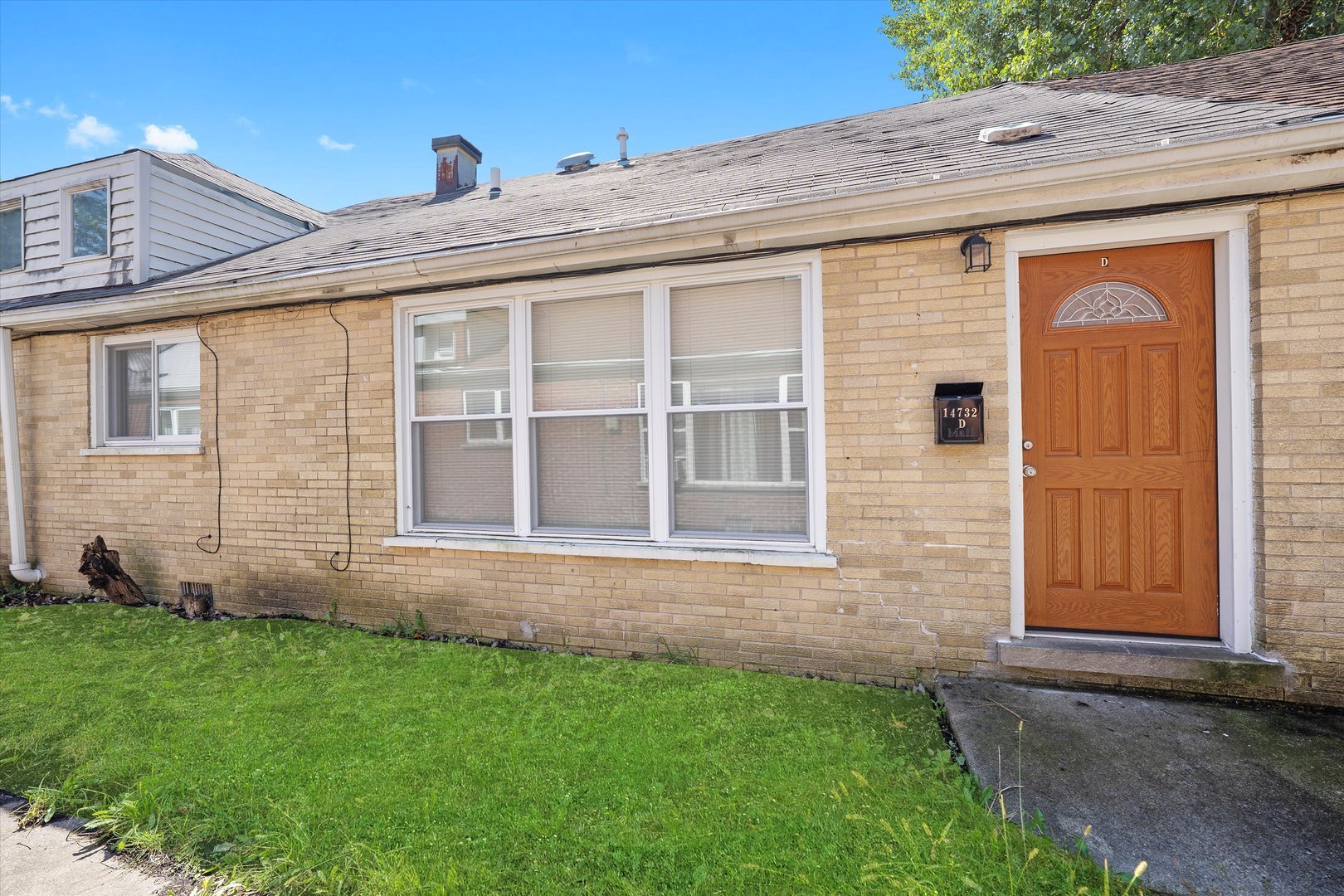 14732 Turner Avenue, Unit D Midlothian, IL 60445 - Photo 1 of 28 a front view of a house with a yard