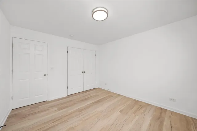a view of a room with wooden floor and window