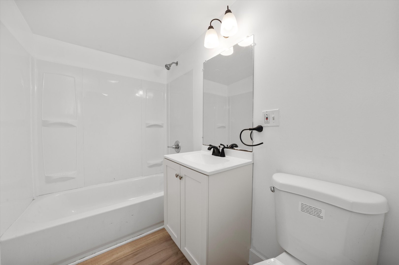 14732 Turner Avenue, Unit D Midlothian, IL 60445 - Photo 19 of 28 a bathroom with a sink a toilet and bathtub