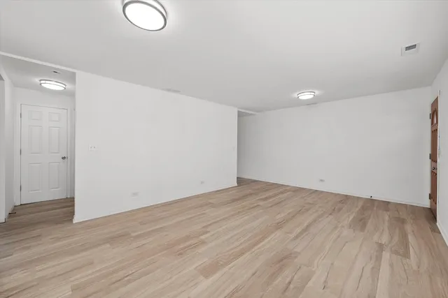 a view of a room with wooden floor