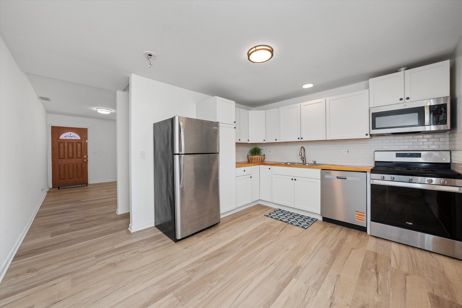 14732 Turner Avenue, Unit D Midlothian, IL 60445 - Photo 8 of 28 a kitchen with a refrigerator and a stove top oven