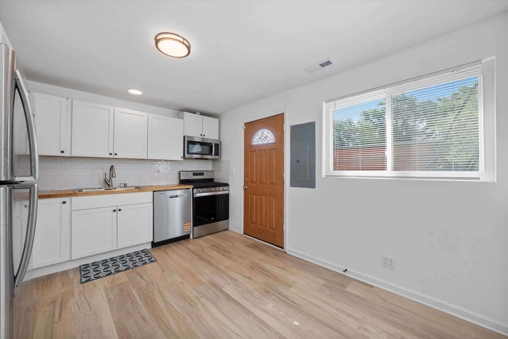 14732 Turner Avenue, Unit D Midlothian, IL 60445 - Photo 9 of 28 a kitchen with a refrigerator and a stove top oven