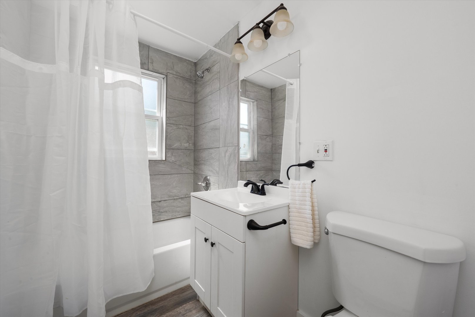 14732 Turner Avenue, Unit D Midlothian, IL 60445 - Photo 10 of 28 a bathroom with a sink toilet and mirror