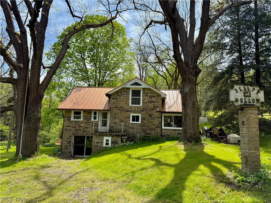 11811 Gaston Road Rogers, OH 44455 - Photo 2 of 38 The Cabin (stone-style facade) features 3 bedrooms, two bathrooms, a full-size basement, and is fully applianced with septic, well, and a geo-thermal furnace! Spend your evenings here while you build-out, or make the cabin your forever getaway and spend your days, hiking, hunting, or fishing!