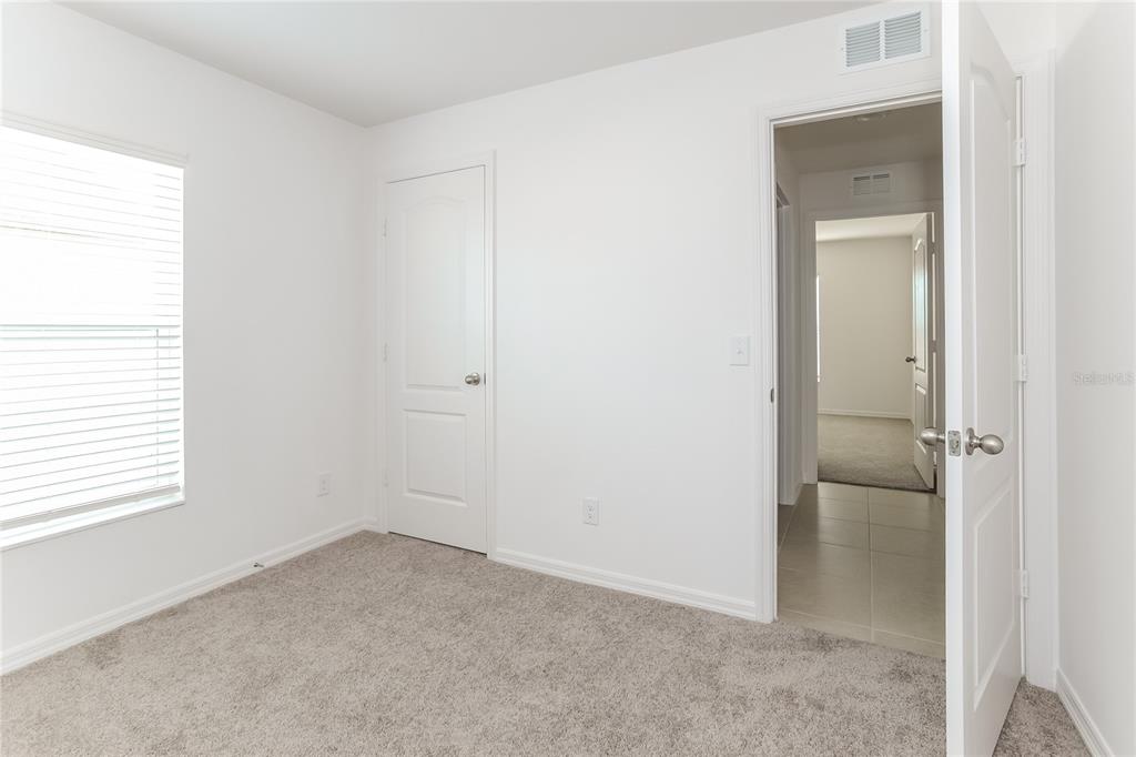 1724 Canaan Loop Dundee, FL 33838 - Photo 11 of 16 a view of an empty room with closet and a window