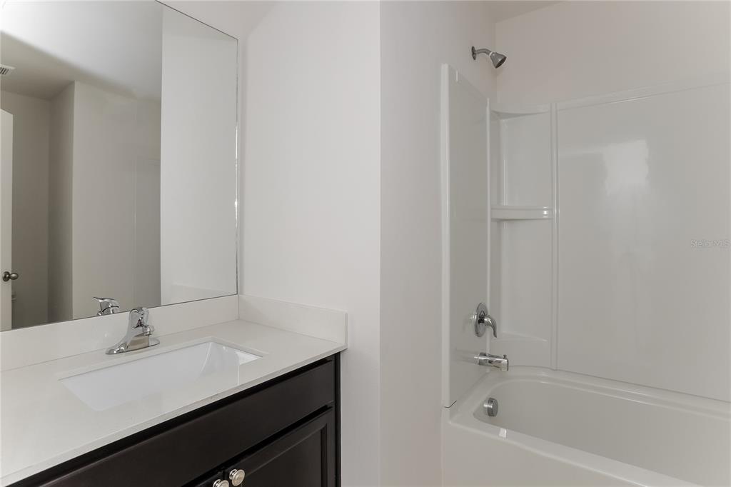 1724 Canaan Loop Dundee, FL 33838 - Photo 13 of 16 a bathroom with a sink and a bathtub