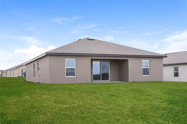 a front view of house with yard and trees