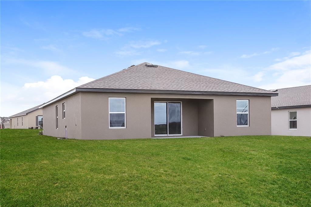 1724 Canaan Loop Dundee, FL 33838 - Photo 14 of 16 a front view of house with yard and trees