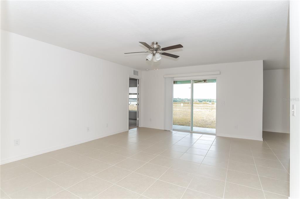 1724 Canaan Loop Dundee, FL 33838 - Photo 2 of 16 an empty room with fan and windows