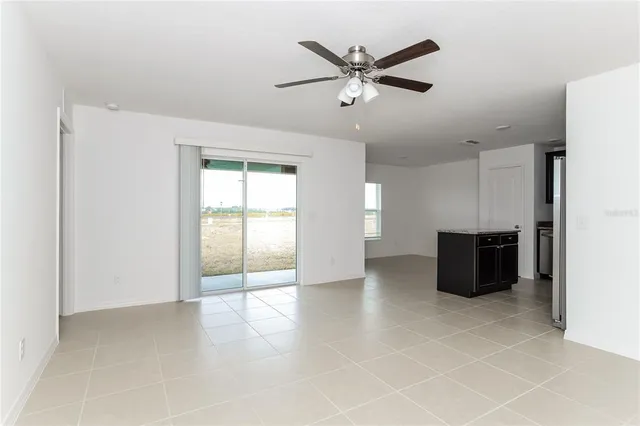 a view of a livingroom with a ceiling fan and window