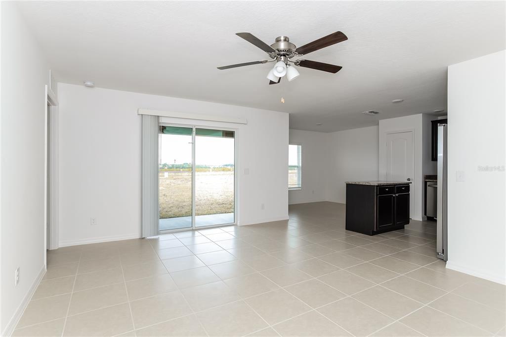 1724 Canaan Loop Dundee, FL 33838 - Photo 3 of 16 a view of a livingroom with a ceiling fan and window