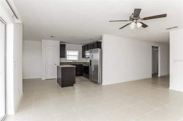 a kitchen with refrigerator and microwave