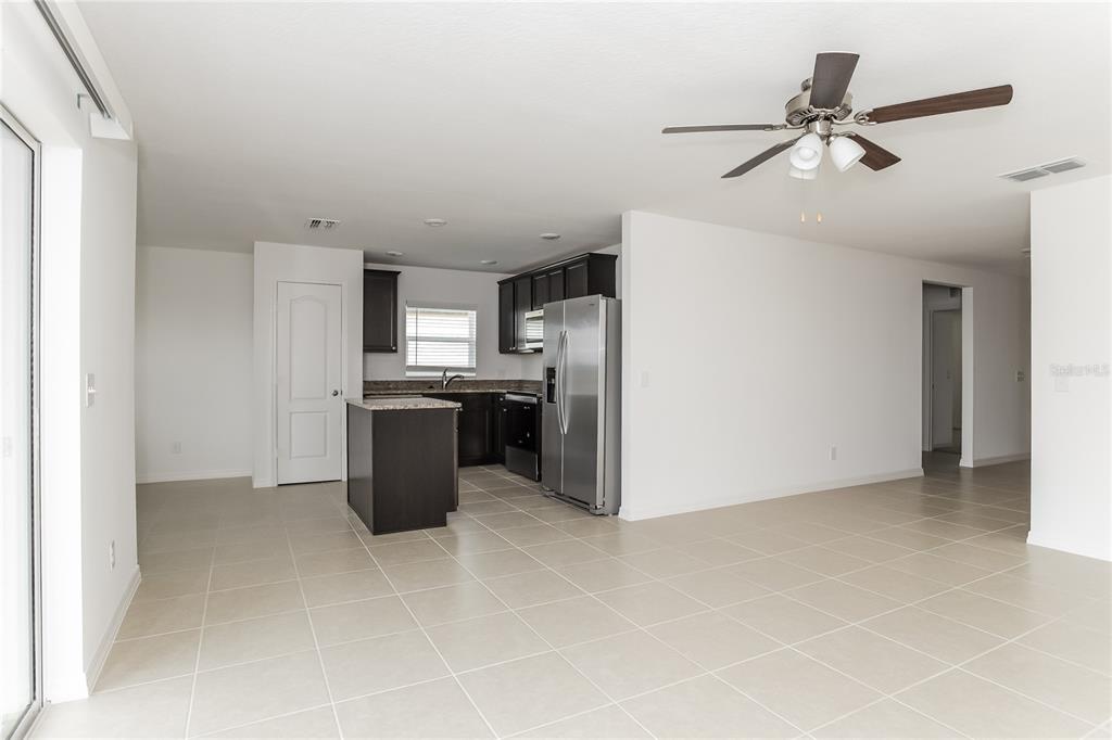 1724 Canaan Loop Dundee, FL 33838 - Photo 4 of 16 a kitchen with refrigerator and microwave