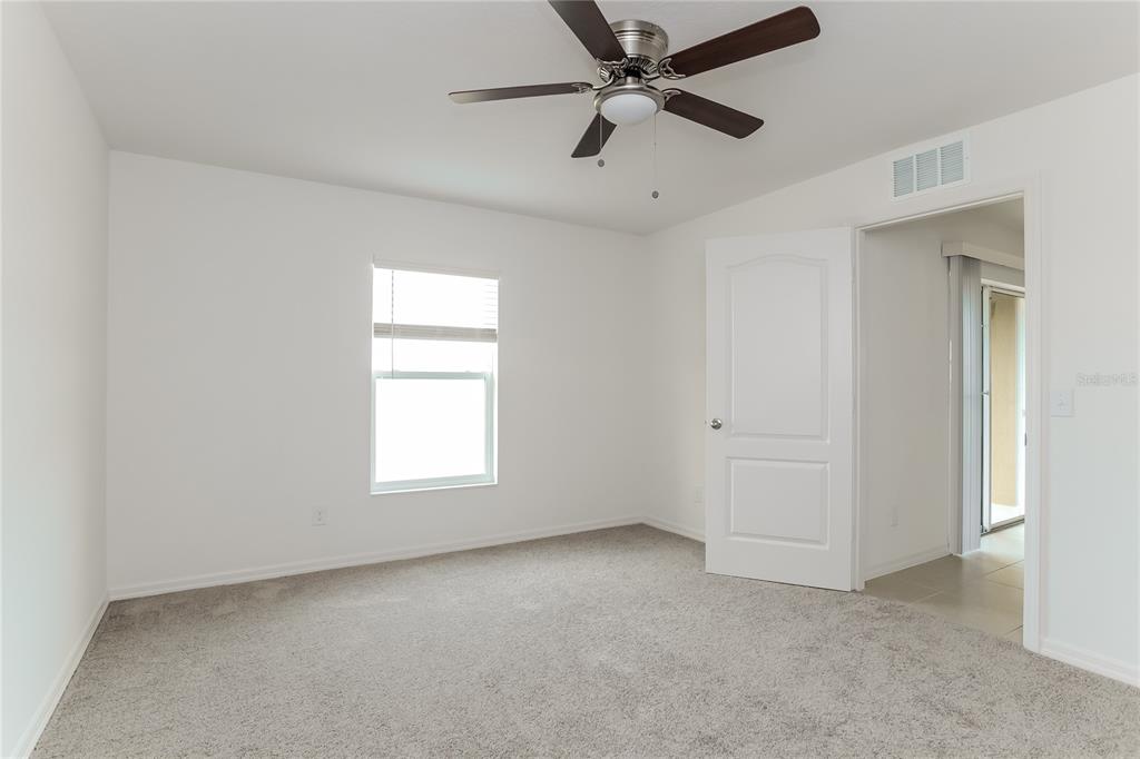 1724 Canaan Loop Dundee, FL 33838 - Photo 8 of 16 an empty room with a window and a fan