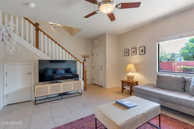 a bedroom with a bed and a large window