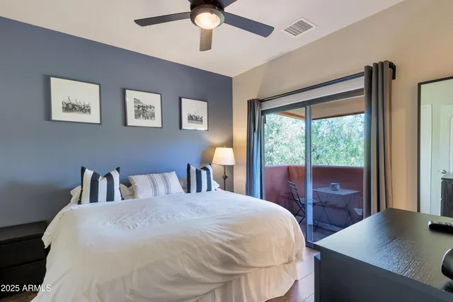 a bedroom with a bed couch and a window