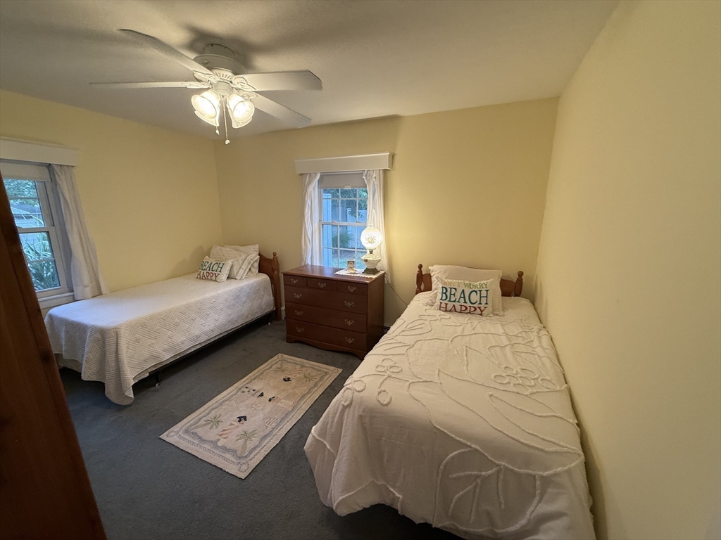 40 Studley Road, Unit 1 Barnstable, MA 02601 - Photo 15 of 24 a bedroom with a bed and a chandelier