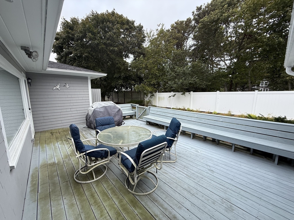 40 Studley Road, Unit 1 Barnstable, MA 02601 - Photo 19 of 24 a backyard of a house with wooden floor and outdoor seating
