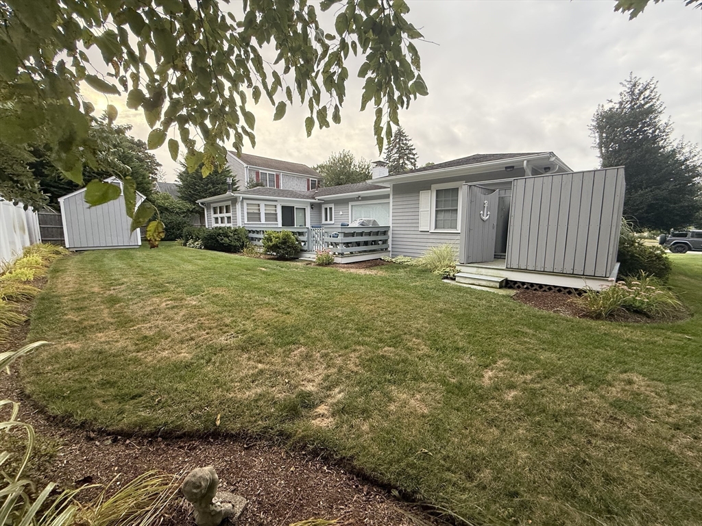 40 Studley Road, Unit 1 Barnstable, MA 02601 - Photo 22 of 24 a front view of a house with a garden and yard