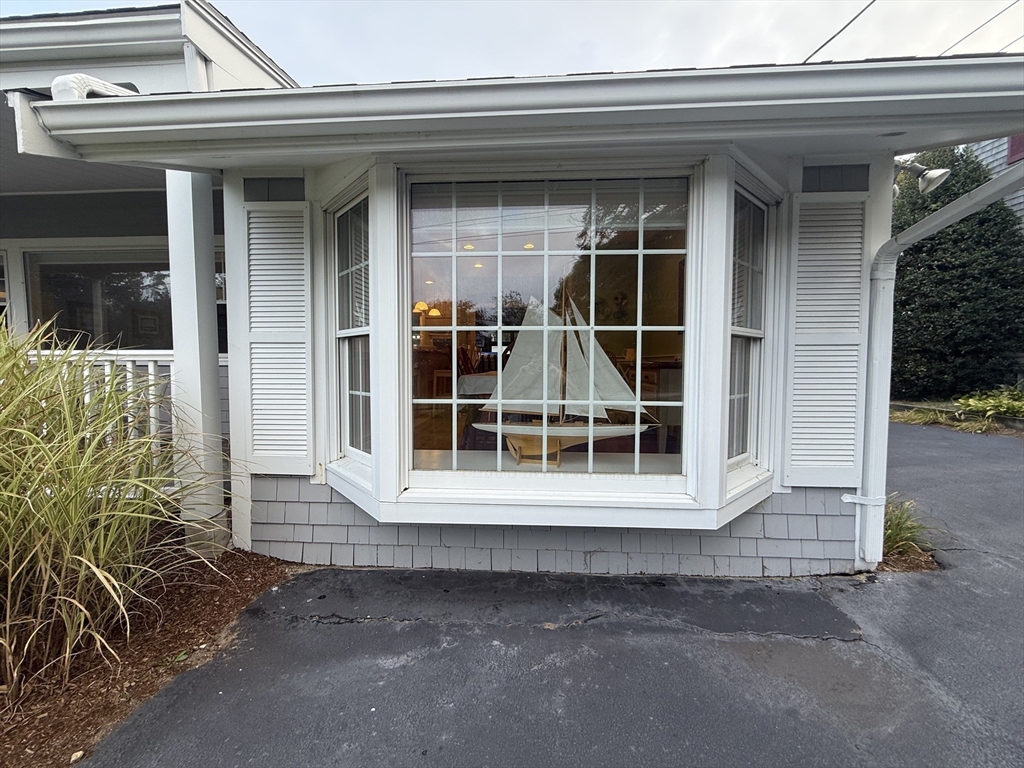40 Studley Road, Unit 1 Barnstable, MA 02601 - Photo 23 of 24 a view of a house with a large window and wooden fence