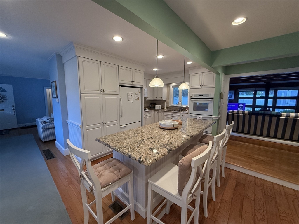 40 Studley Road, Unit 1 Barnstable, MA 02601 - Photo 6 of 24 a kitchen with stainless steel appliances granite countertop a table chairs sink and cabinets