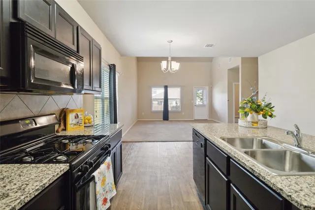 a kitchen that has a sink and a stove