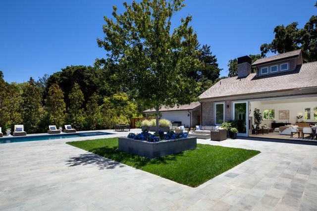 a view of house with outdoor space and swimming pool