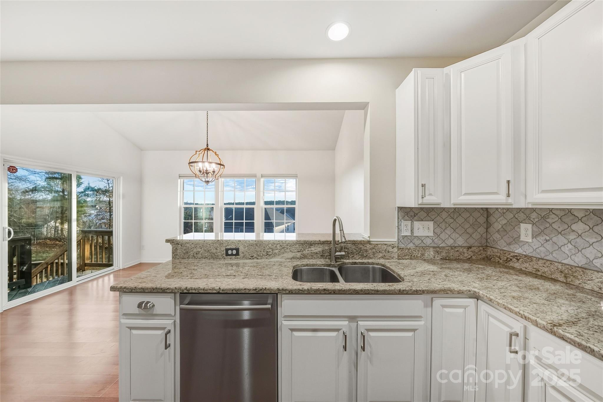 2155 Galloway Lane Southwest Concord, NC 28025 - Photo 11 of 40 a kitchen with stainless steel appliances granite countertop a sink and a white cabinets