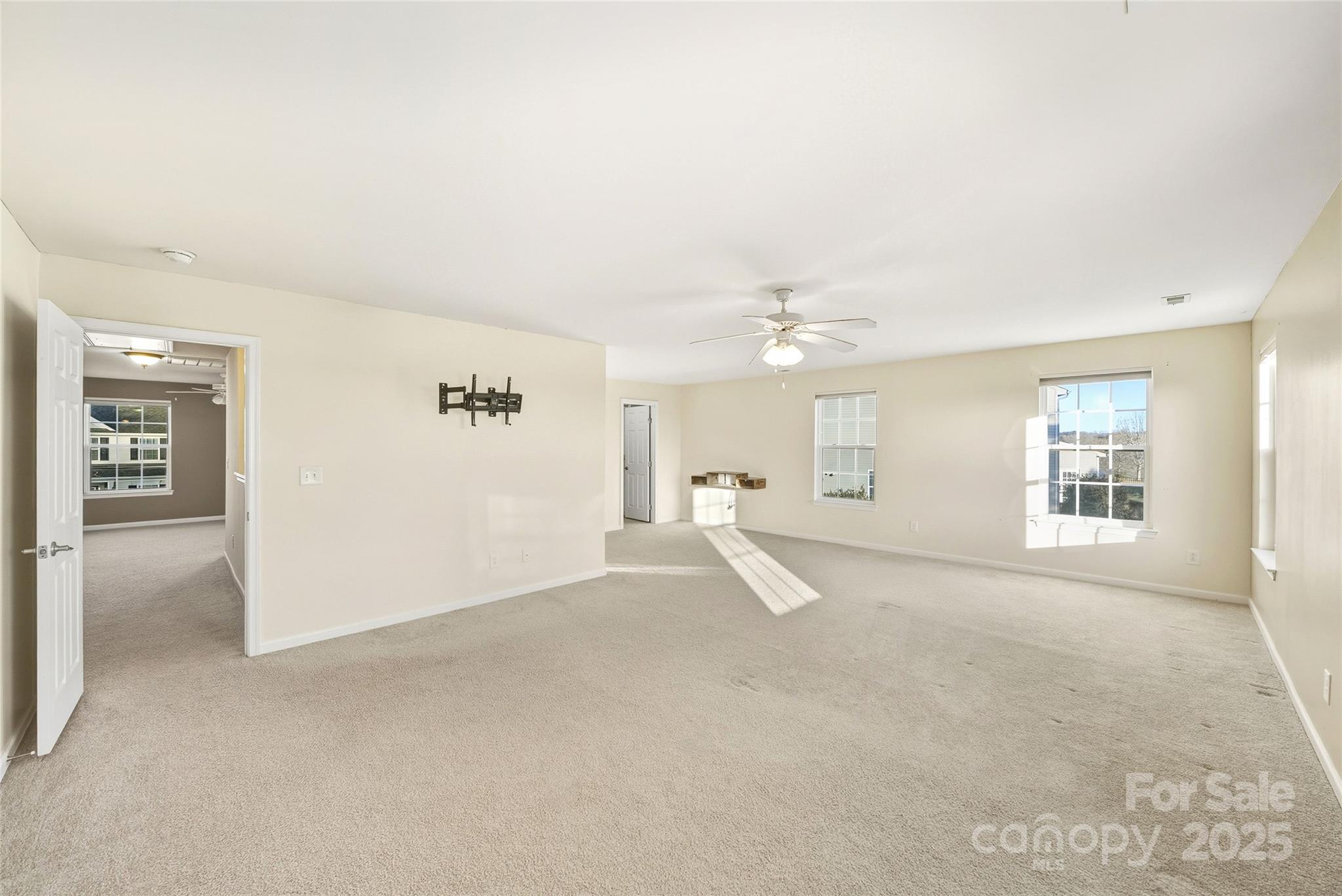 2155 Galloway Lane Southwest Concord, NC 28025 - Photo 22 of 40 a view of empty room with windows and ceiling fan