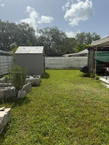 a view of a house with sitting area and a yard