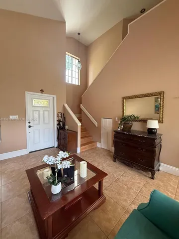 a living room with furniture and a piano