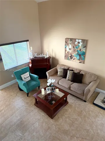 a living room with furniture rug and window