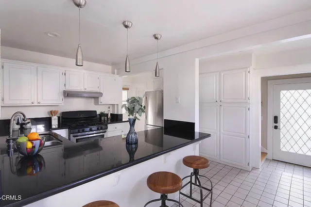 a kitchen with stainless steel appliances granite countertop a stove and a refrigerator