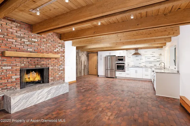 a view of empty room with a fireplace