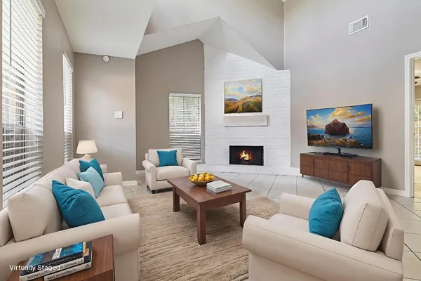 a living room with furniture and a fireplace