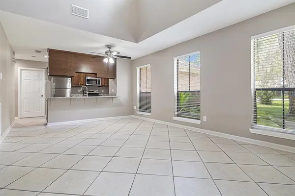 a view of an empty room with window and cabinet
