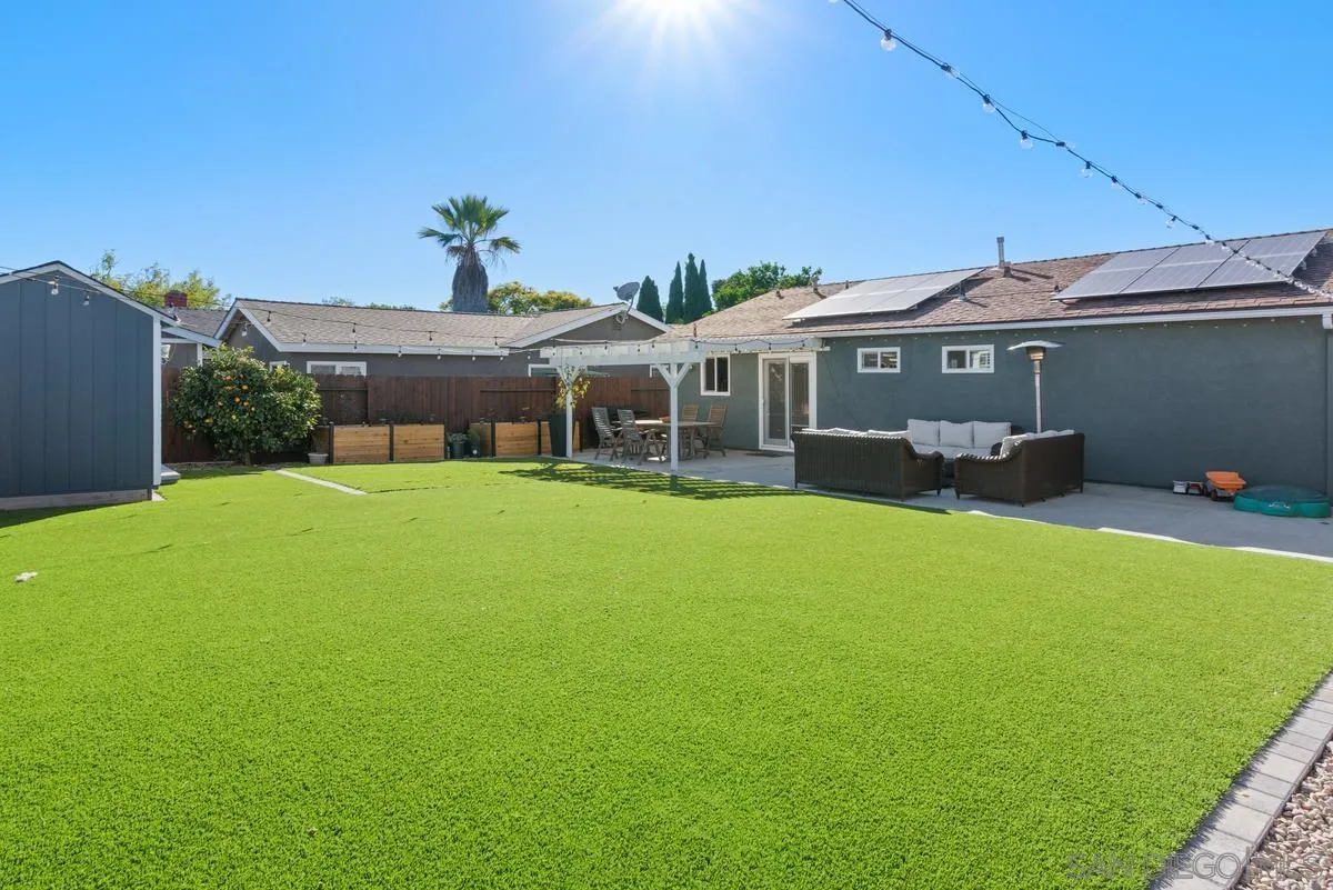 a view of a house with a backyard porch and sitting area