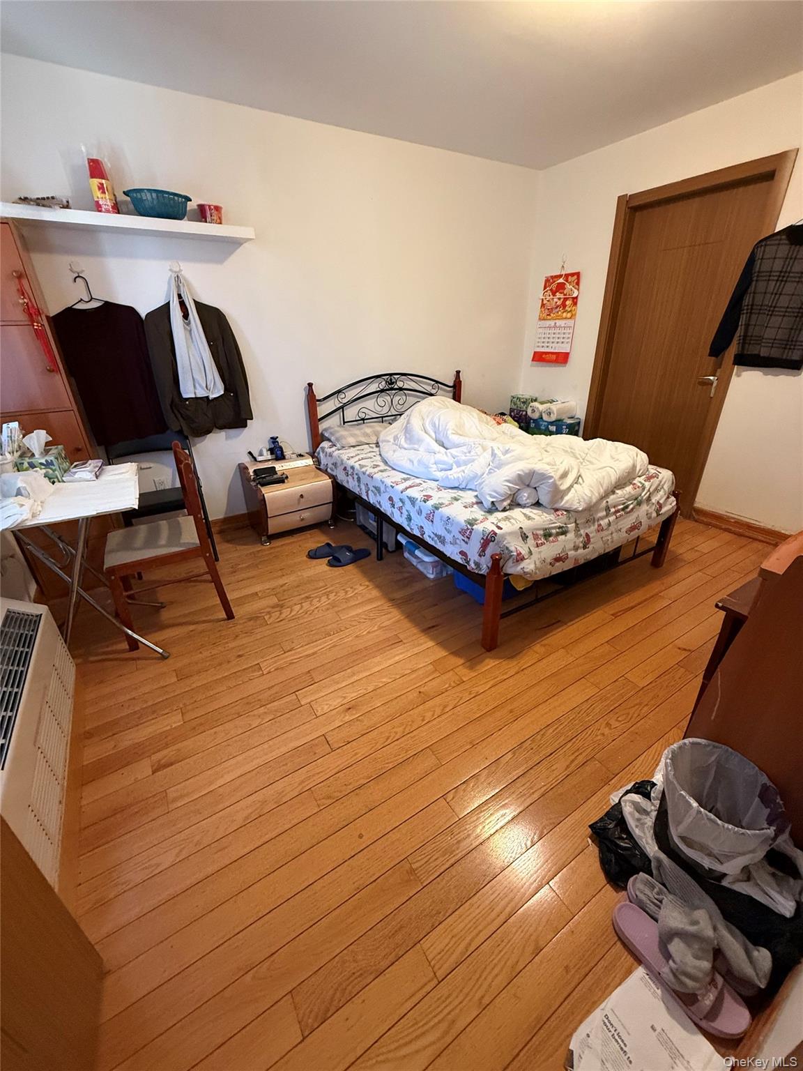 37-17 111th Street, Unit 2D Queens, NY 11368 - Photo 4 of 8 a bedroom with a bed and wooden floor