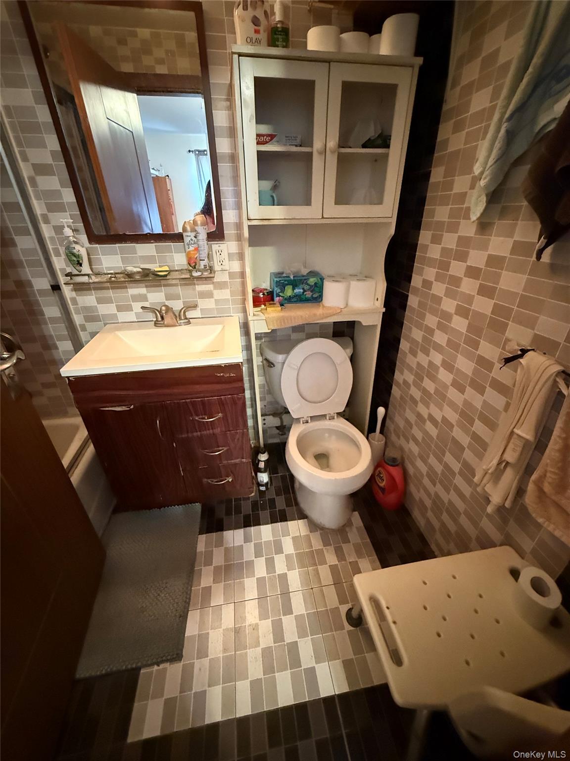 37-17 111th Street, Unit 2D Queens, NY 11368 - Photo 7 of 8 a bathroom with a sink and a mirror