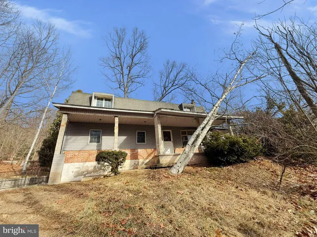 a view of a blue house with large windows
