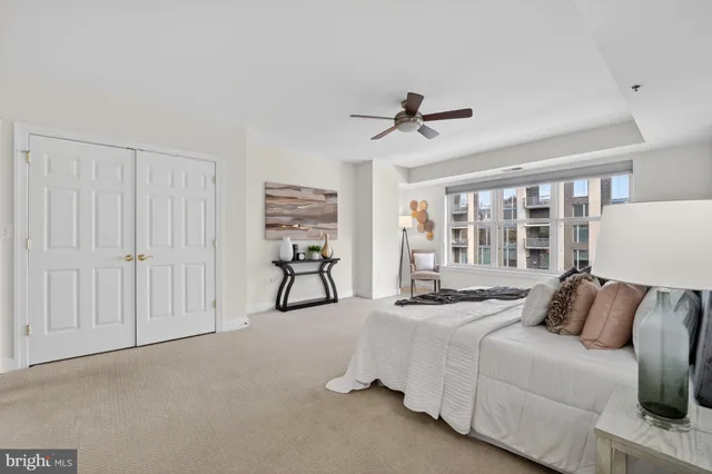 a bedroom with furniture and a ceiling fan