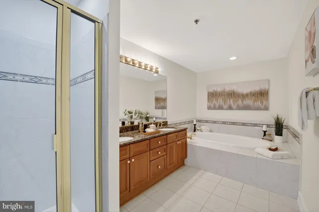 a bathroom with a tub a sink and mirror