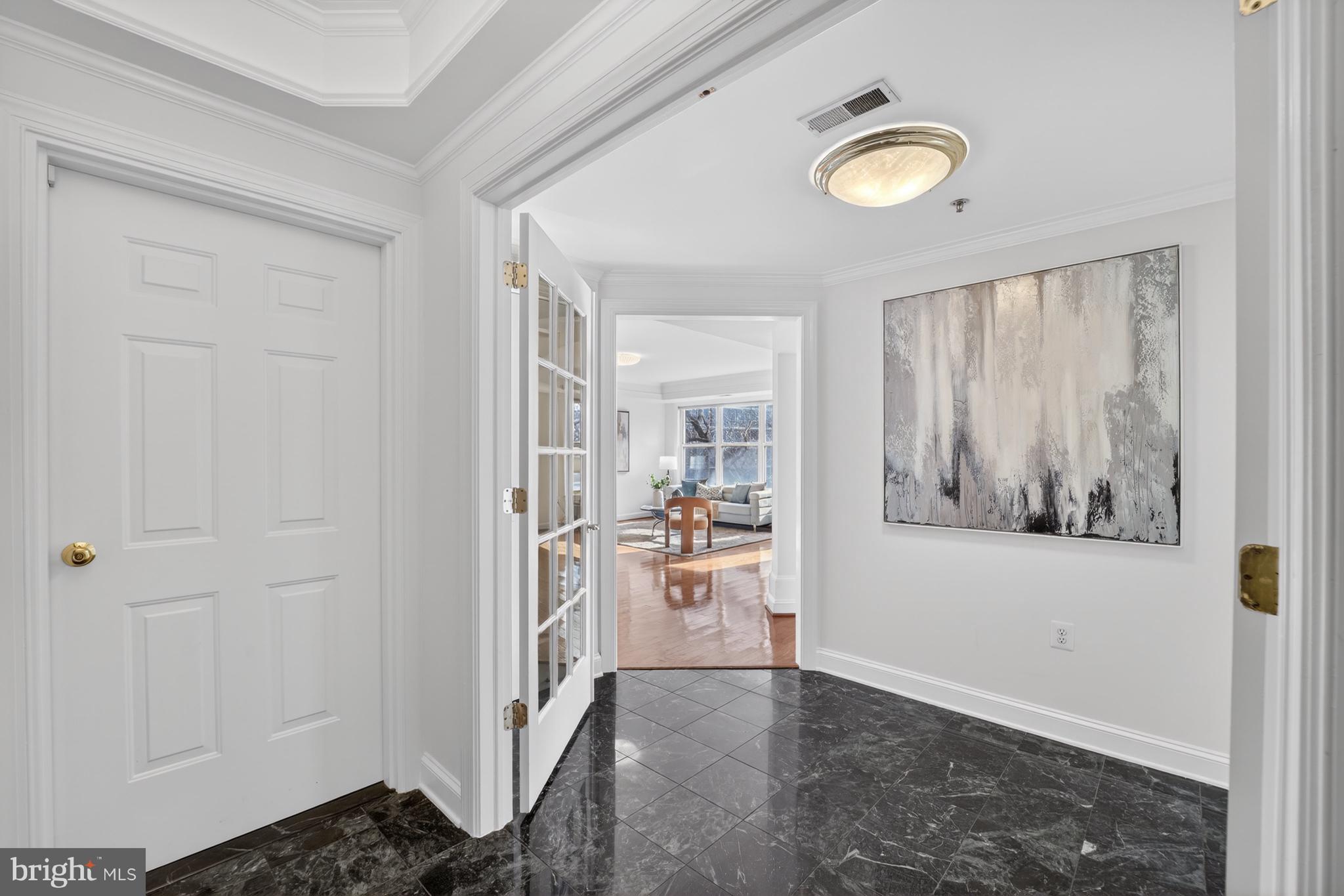1555 North Colonial Terrace, Unit 601 Arlington, VA 22209 - Photo 2 of 24 a view of a hallway to a livingroom with furniture and window