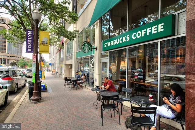 a view of a chairs and table in patio next to a building