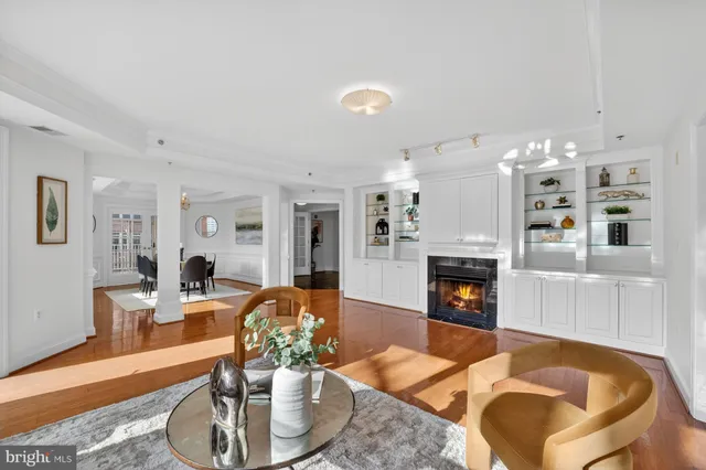 a living room with fireplace furniture and a wooden floor